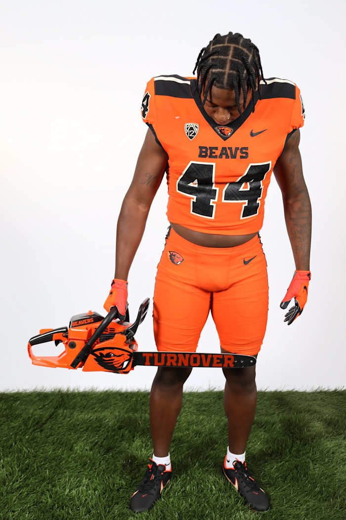 Melvin Jordan poses with the turnover chainsaw during a photoshoot in Corvallis.